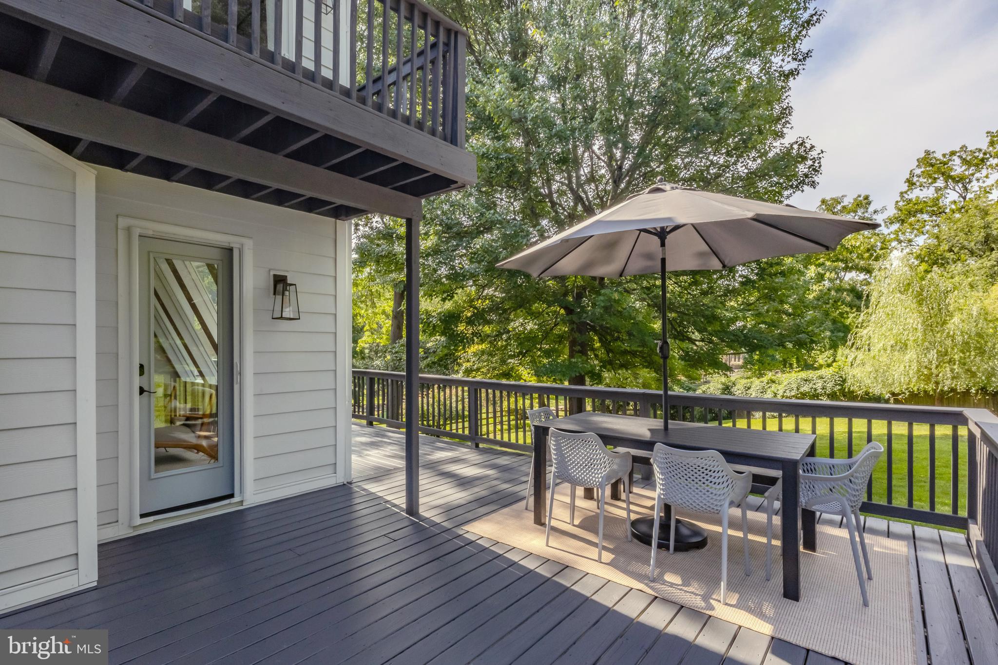 65 Roberts Road Newtown Square, PA 19073 - Photo 51 of 53 a patio with wooden floor a yard a table and chairs