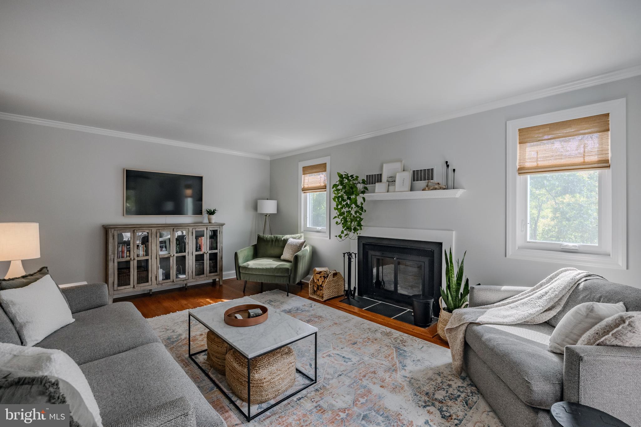 65 Roberts Road Newtown Square, PA 19073 - Photo 8 of 53 a living room with furniture a flat screen tv and a fireplace