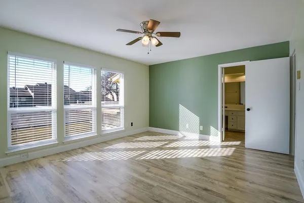 a view of a livingroom with wooden floor and a ceiling fan