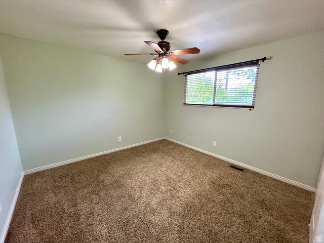 441 South 400 East Payson, UT 84651 - Photo 19 of 39 Carpeted room with a ceiling fan light fixture, light green walls, a window with blinds, and white baseboards
