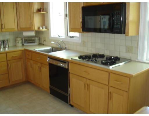 25 Goodnough Road Brookline, MA 02467 - Photo 3 of 7 a kitchen with a sink a stove and cabinets