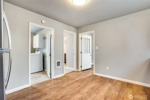a view of a room with wooden floor and a bathroom
