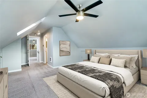 a bedroom with a large bed and a chandelier