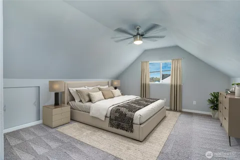 a bedroom with a large bed and ceiling fan