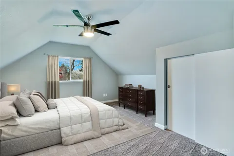 a bedroom with a bed and ceiling fan