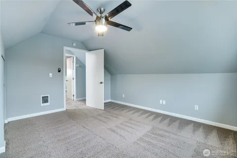 an empty room with closet and fan