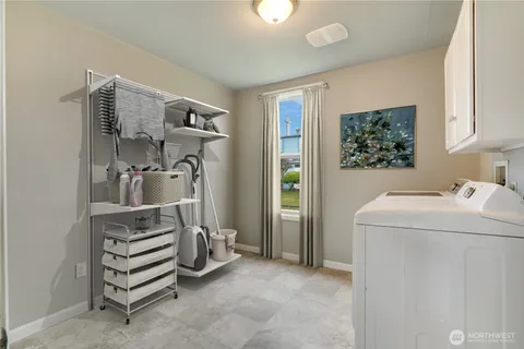 a view of storage and utility room with washer and dryer