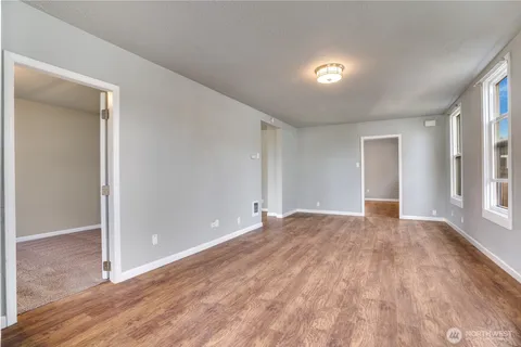 wooden floor in an empty room with a window