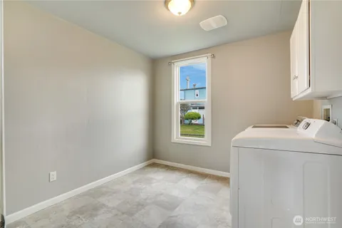 a view of storage and utility room with a window
