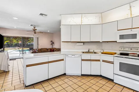 a kitchen with cabinets appliances and a window