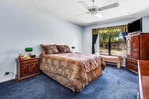 a bedroom with a bed dresser and a window