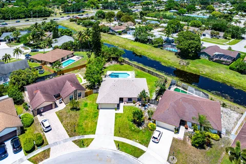 an aerial view of residential houses with outdoor space and street view