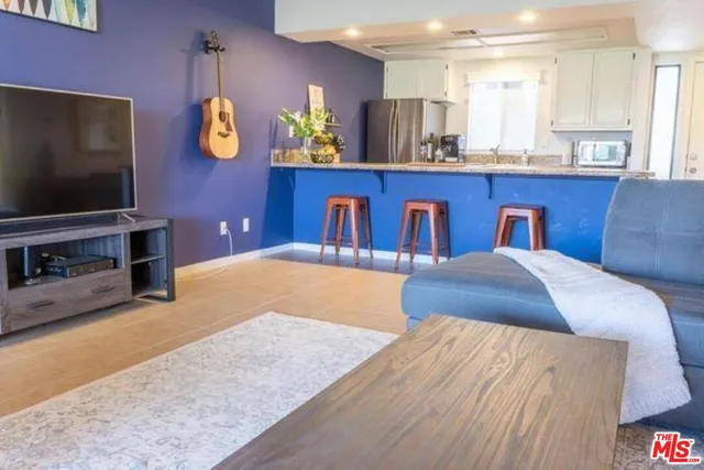 a bedroom with a bed and painting on the wall