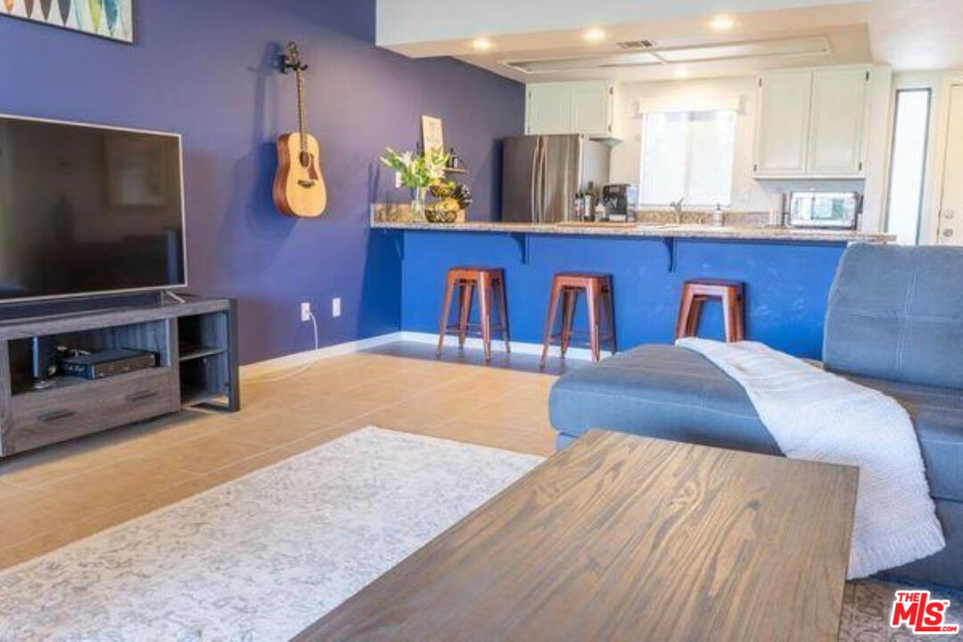 77116 Pauma Valley Way Palm Desert, CA 92211 - Photo 3 of 15 a bedroom with a bed and painting on the wall