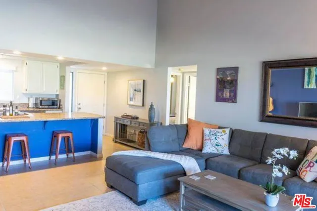 a living room with furniture with kitchen view