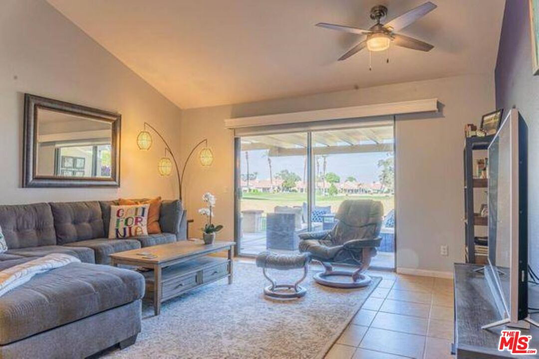 77116 Pauma Valley Way Palm Desert, CA 92211 - Photo 6 of 15 a living room with furniture and a large window