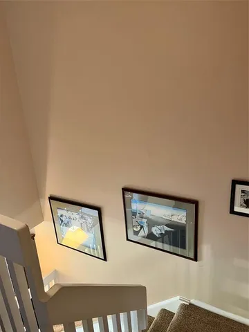 a view of a hallway with paintings on the wall