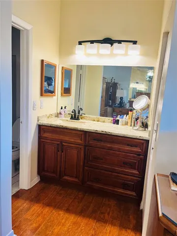 a bathroom with a double vanity sink and a mirror