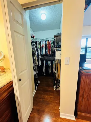 a view of a hallway with wooden floor and stairs
