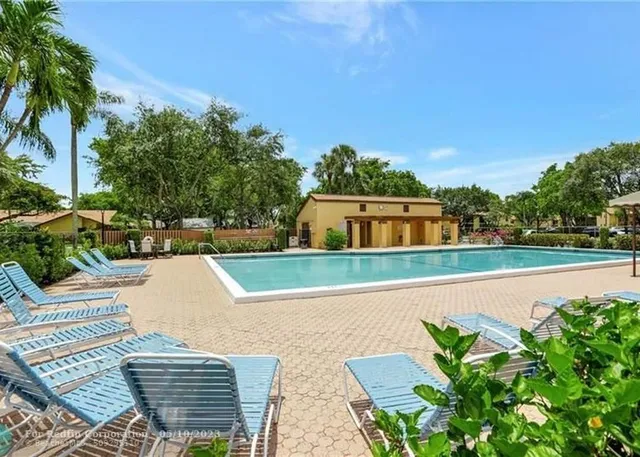 a view of house with swimming pool outdoor seating