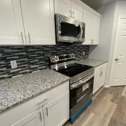 a kitchen with a stove microwave and sink