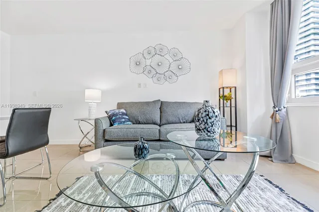 a living room with a couch and a chandelier