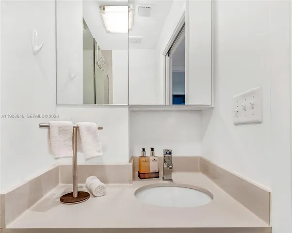 a bathroom with a shower a toilet and sink