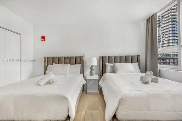 a bedroom with a bed and a white cabinet