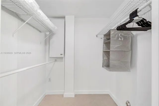 a bedroom with a bed and a table chair