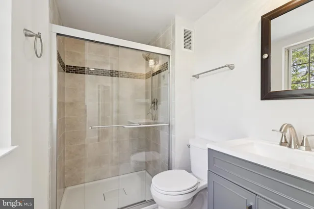 a bathroom with a shower toilet and sink