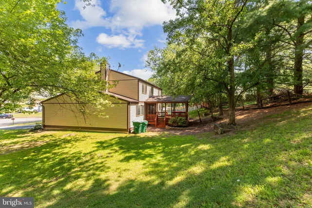 a view of a yard with a house in the background