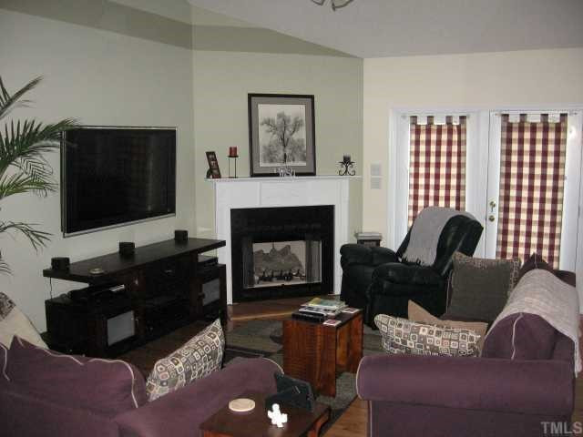 238 South Ridge Drive Garner, NC 27529 - Photo 5 of 9 sunken living area with cathedral ceiling and fireplace with gas logs