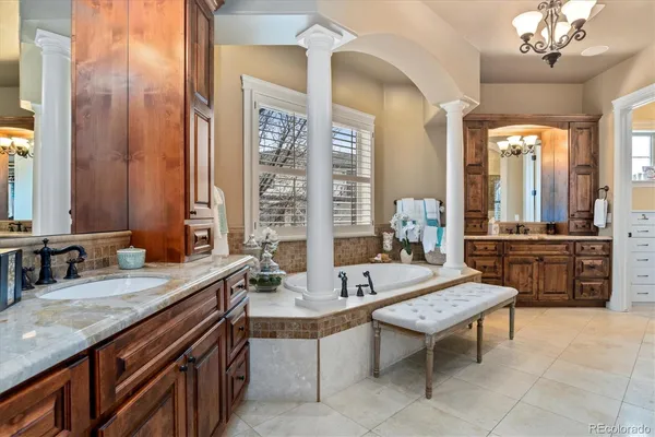 a spacious bathroom with a granite countertop sink and a mirror