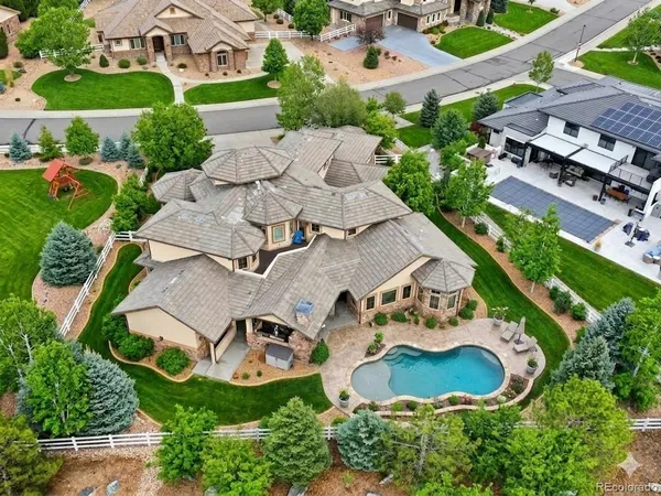 an aerial view of a house with garden space and street view