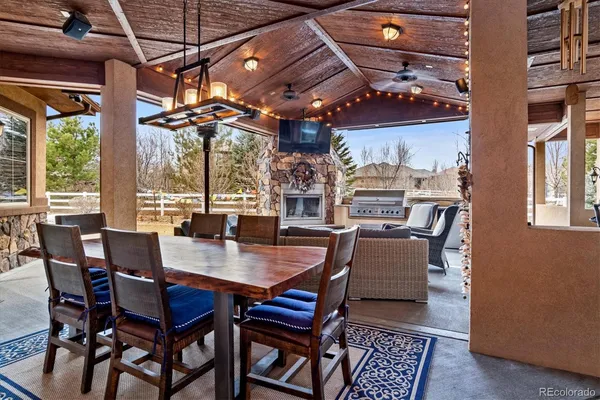 a outdoor living space with patio furniture and a fireplace