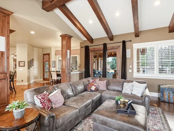a living room with furniture and floor to ceiling windows