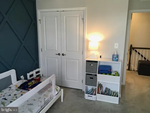a view of staircase with white walls and white door