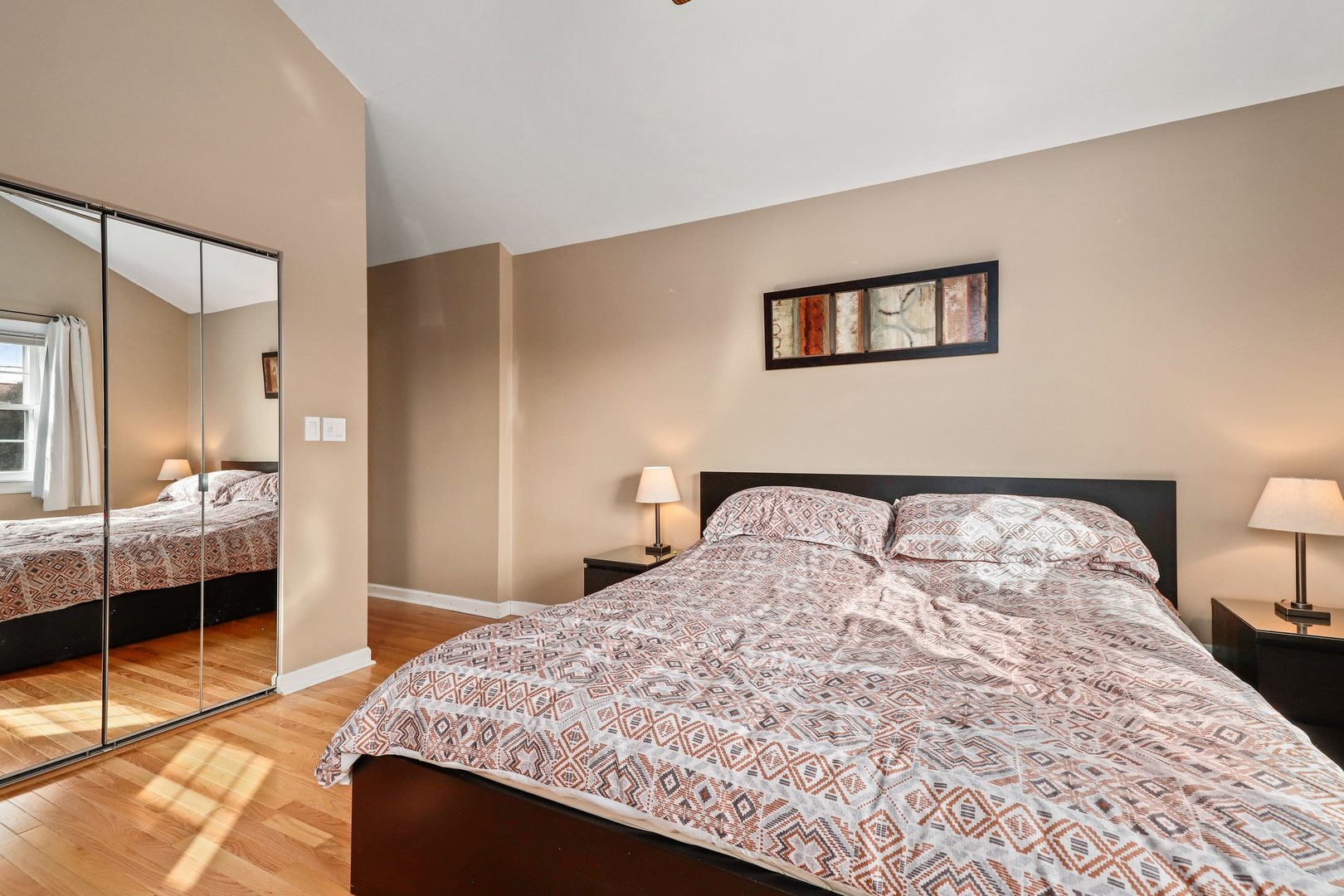 5815 North Canfield Avenue Chicago, IL 60631 - Photo 15 of 31 a bedroom with a large bed and a view of bathroom