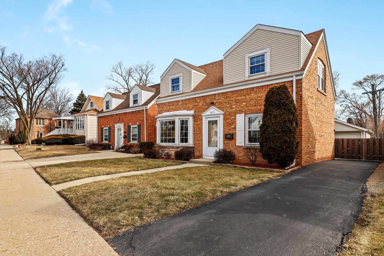 5815 North Canfield Avenue Chicago, IL 60631 - Photo 29 of 31 a view of a white house with a large windows next to a road