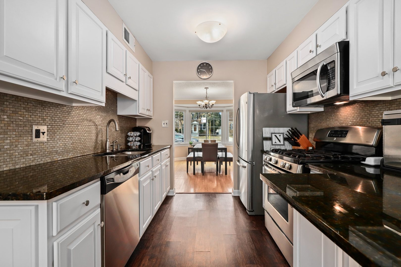 5815 North Canfield Avenue Chicago, IL 60631 - Photo 6 of 31 a kitchen with stainless steel appliances granite countertop a stove top oven a sink dishwasher and a refrigerator