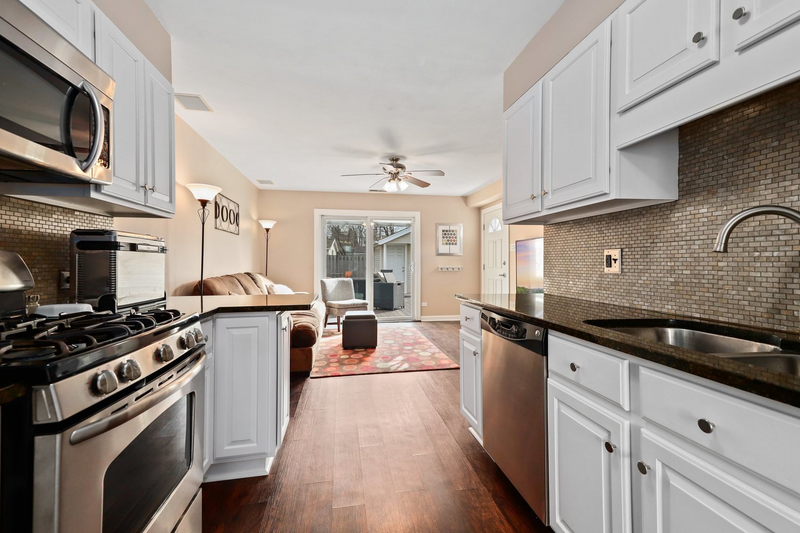 5815 North Canfield Avenue Chicago, IL 60631 - Photo 7 of 31 a kitchen with stainless steel appliances a sink stove and cabinets