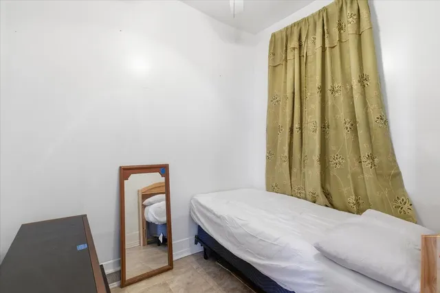 a bedroom with a bed and a painting on the wall