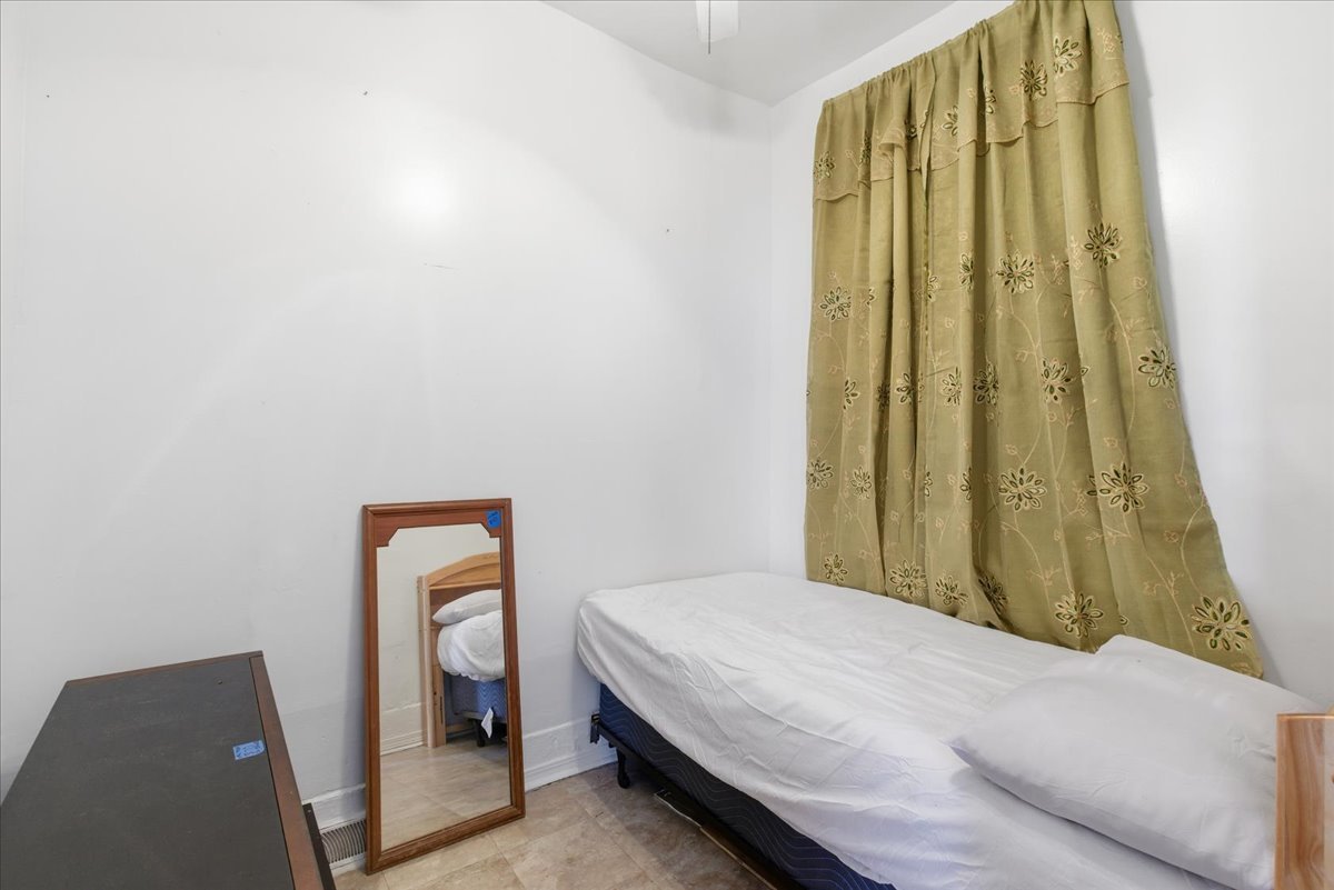 516 West 45th Place Chicago, IL 60609 - Photo 9 of 12 a bedroom with a bed and a painting on the wall