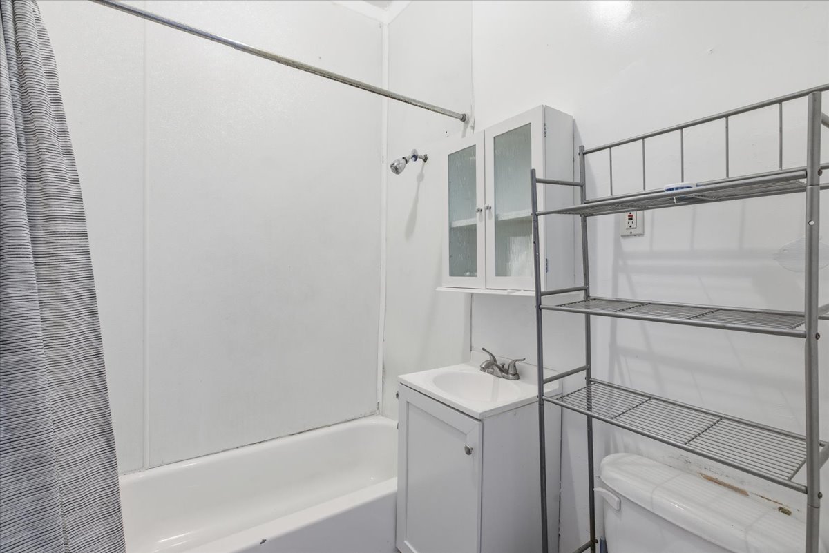 516 West 45th Place Chicago, IL 60609 - Photo 10 of 12 a bathroom with a shower and a sink
