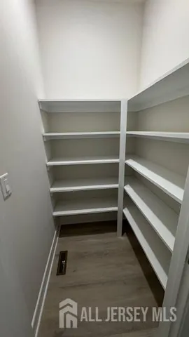 a view of an empty room and wooden floor