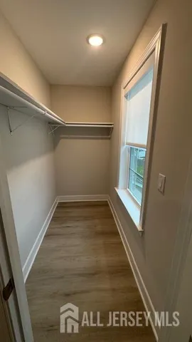 a view of a room with wooden floor and bench
