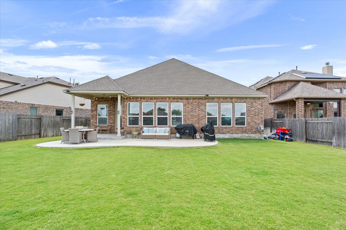 424 Millard Street Georgetown, TX 78628 - Photo 35 of 37 A spacious backyard with a generous patio offers ample room for outdoor living and recreation.