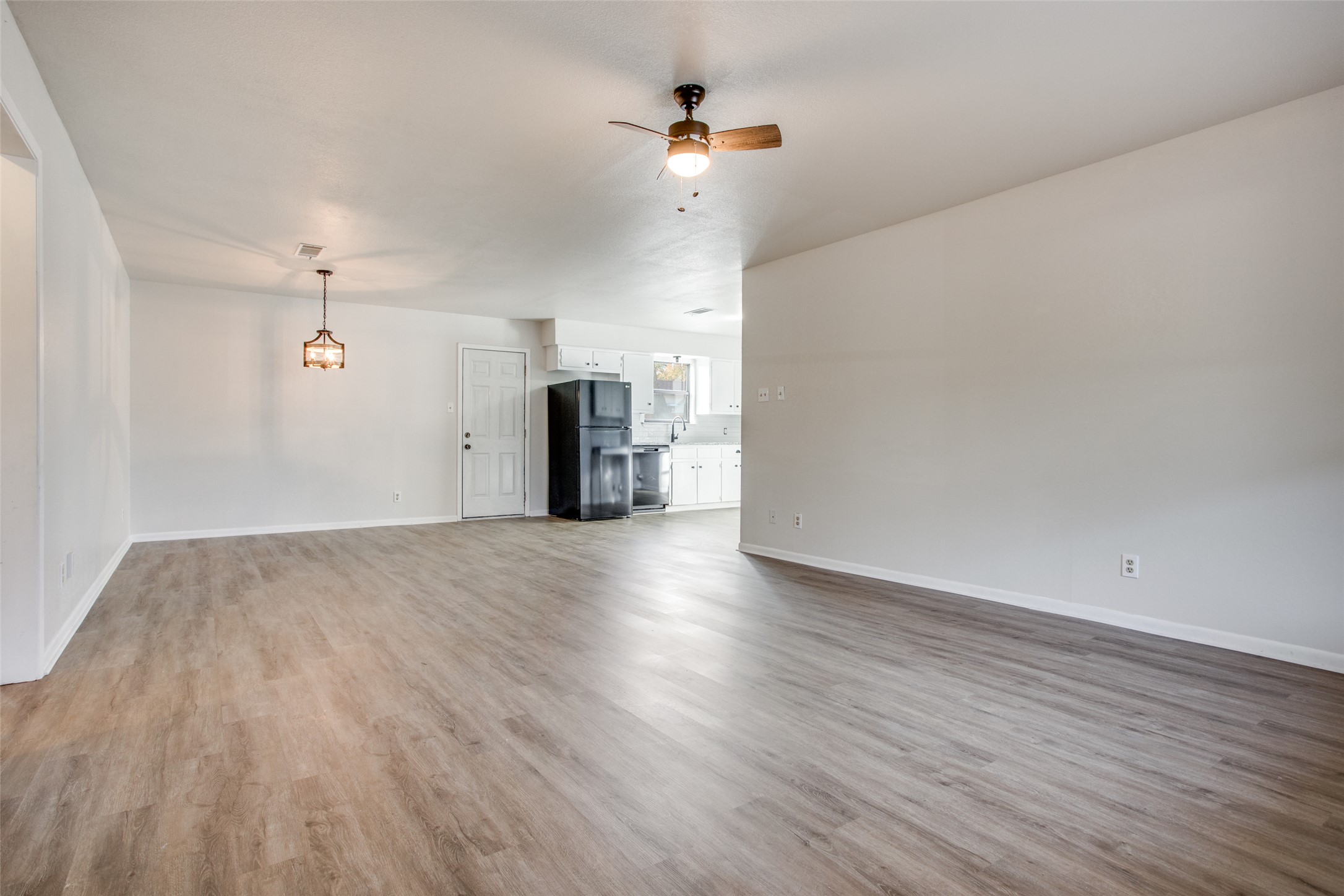 2212 Rifle Bend Drive Georgetown, TX 78626 - Photo 3 of 15 a view of empty room with wooden floor and ceiling fan