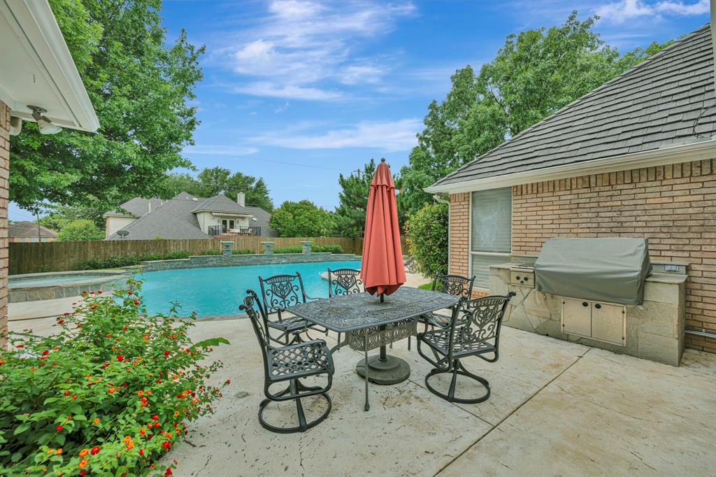 4008 Ramsgate Court Colleyville, TX 76034 - Photo 30 of 33 Expansive concrete patio featuring a built-in outdoor kitchen with grill station