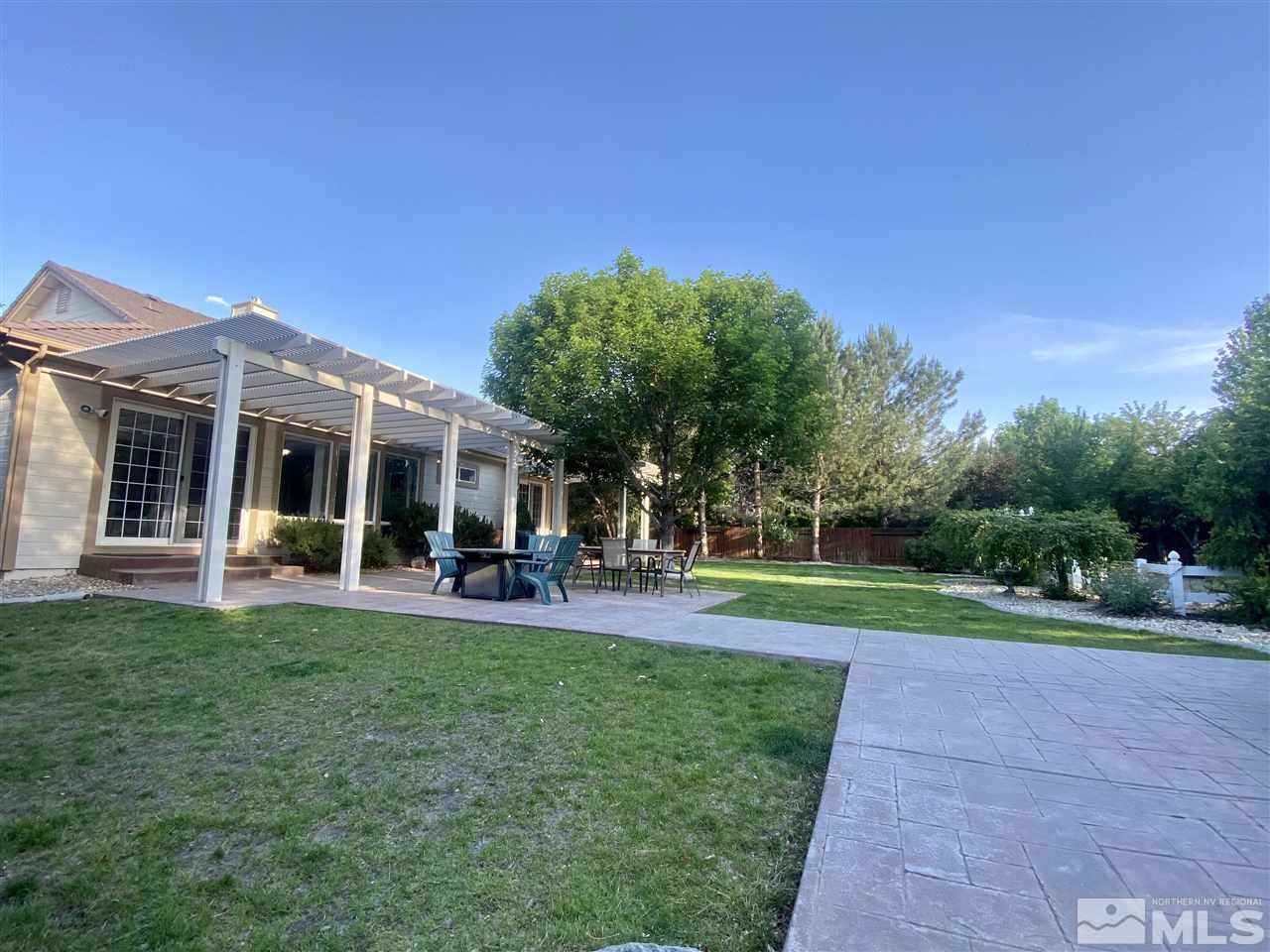 495 Flanders Road Reno, NV 89511 - Photo 21 of 27 a view of a house with a yard and sitting area